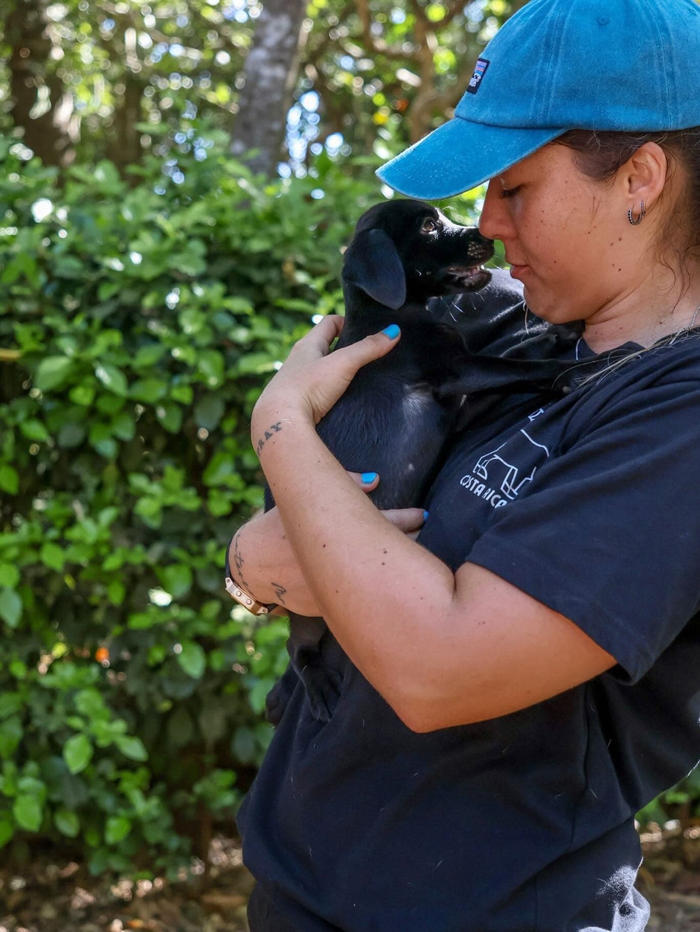 A Halfway Home volunteer with a puppy