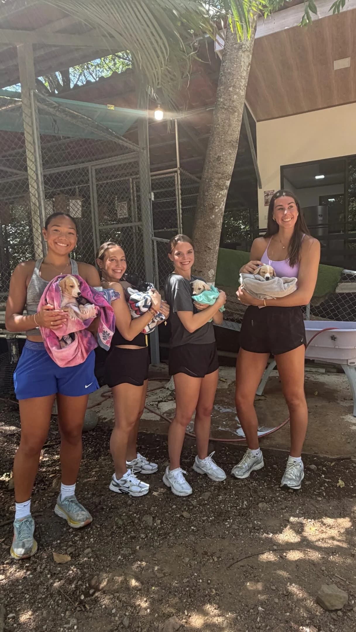 Halfway Home volunteers holding rescue puppies